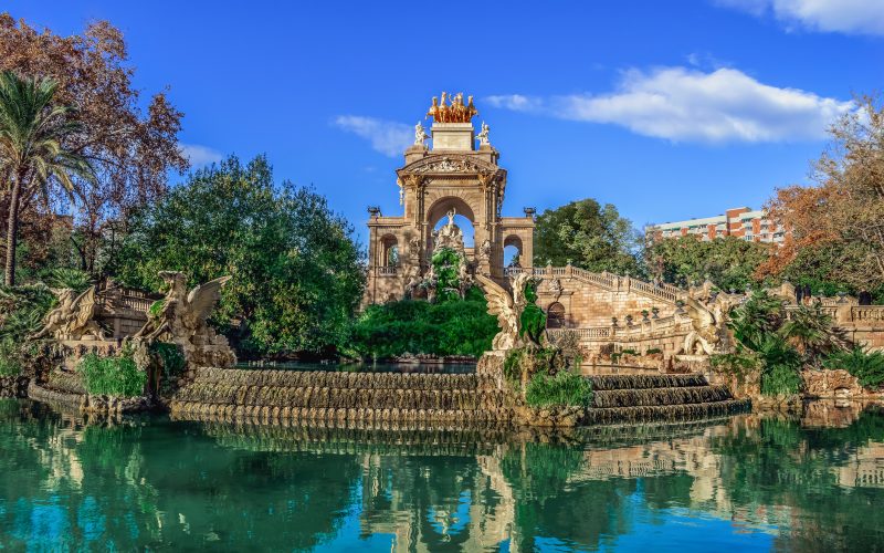 Cascada waterfall in Ciutadella Park in Barcelona, Spain. Antique sculptures of dragons against the backdrop of an arch with statues of Roman gods in the middle of a pool of water