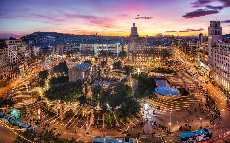 aerial view of Catalonia square, Plaça de Catalunya, at sunset with christmas lights on. Barcelona. Spain