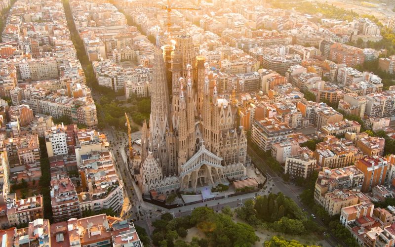 Temple Expiatori La Sagrada Familia in Barcelona, Catalonia, Spain. Flying around the architectural masterpiece of Gaudi at sunrise.